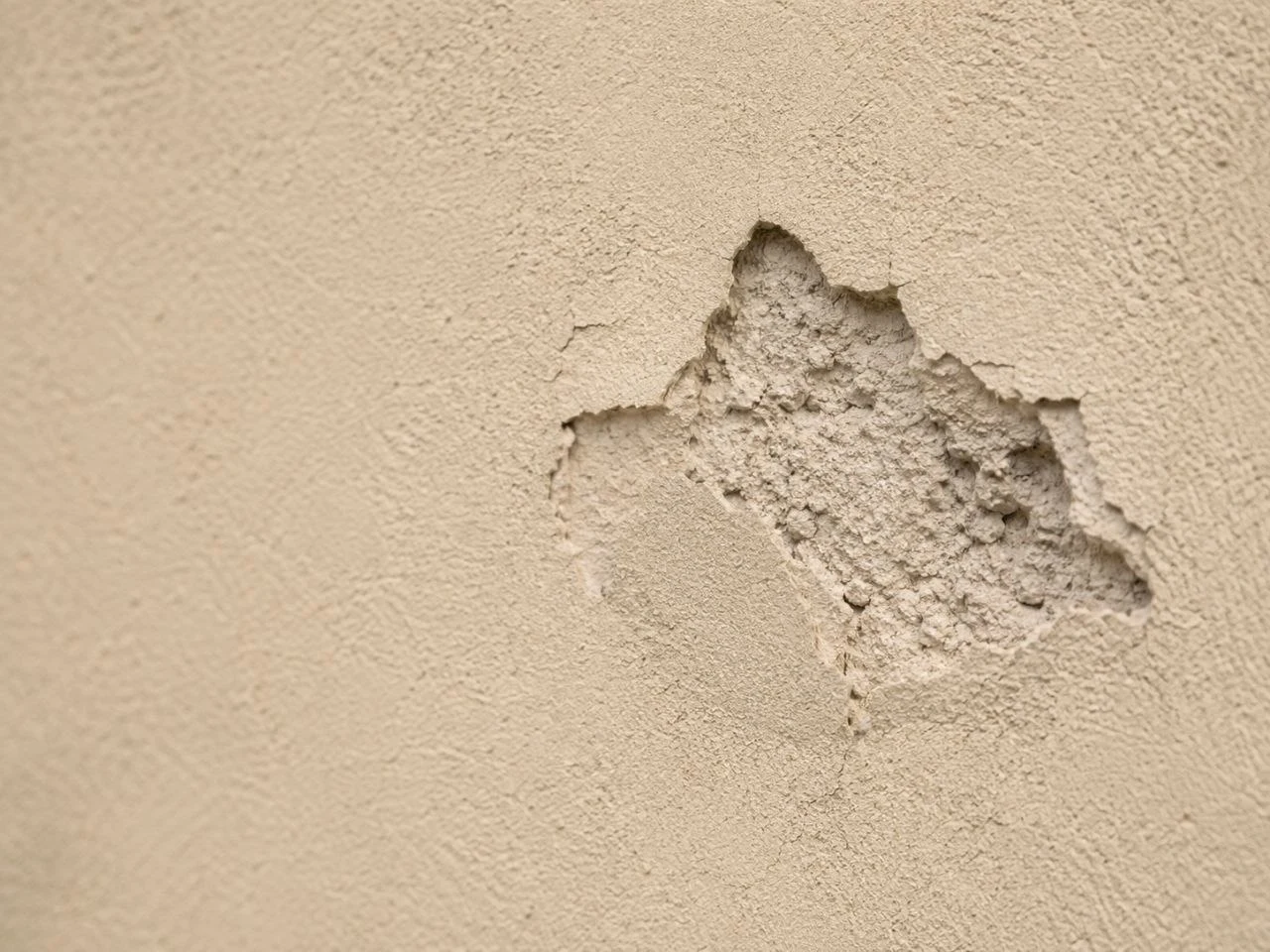 Small chipped area in stucco finish